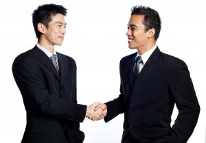 two_business_men_shaking_hands_closing_a_deal