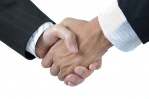 businessmen_shaking_hands_to_close_a_deal