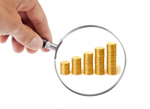 magnifying_glass_focused_on_coins_to_figure_basis_points